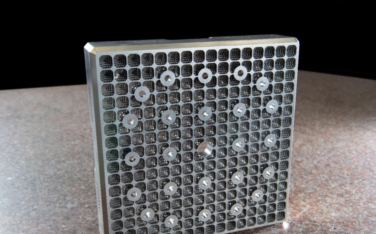 A close-up of a 3D-printed metal fuel grid prototype, representing advanced nuclear energy technology used in next-generation reactors.