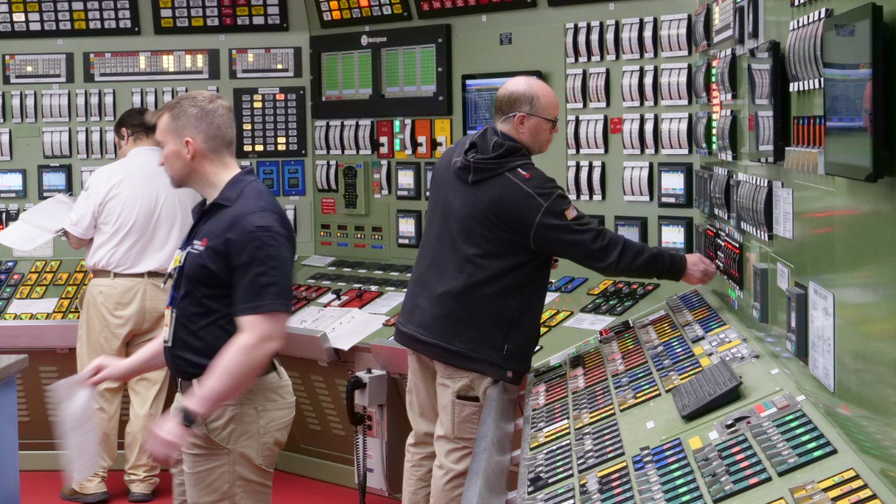 Southern Nuclear operators monitor systems in a control room, emphasizing precision and training in nuclear energy technology operations.